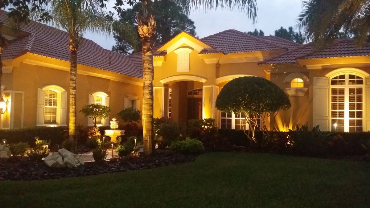 Architectural and landscape lighting on a luxury home in New Port Richey FL by At Your Service Electric